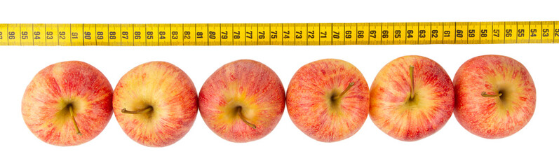 Red apples with a yellow tape-measure