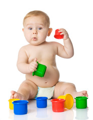 Baby playing with cup toys. Isolated on white background