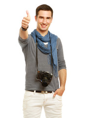 A smiling man with camera showing thumb up sign