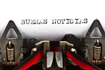 typewriter with text buenas noticias