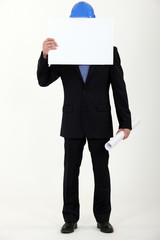 Engineer covering his face with a blank sign