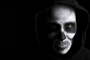 Scary skeleton on black background