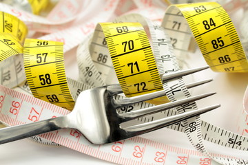 Various tape measure and fork.  Diet concept.