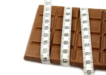 Chocolate and tape measure. Diet concept