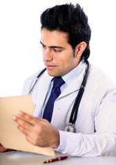 A male doctor sitting at the desk on white background