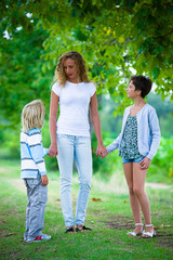 Beautiful Young Woman with Two Children Outside