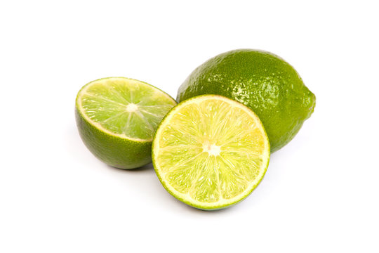 One whole lime and one half lime on white