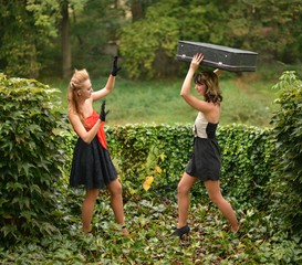 two retro women fighting for suitcase