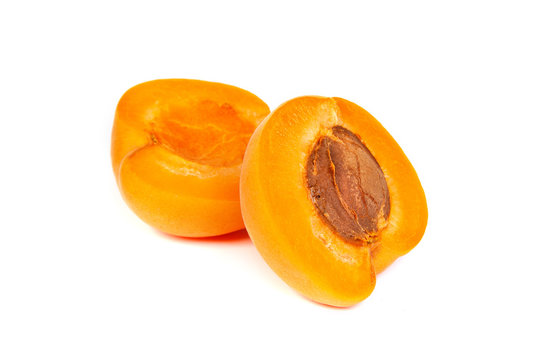 Two ripe apricot sectioned by knife