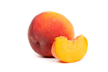 One tasty juicy peache wtih slice  on a white background
