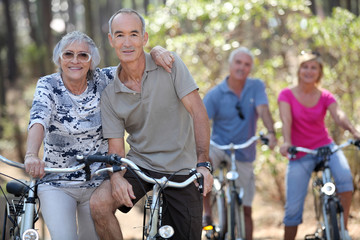 Elderly people riding their bikes - obrazy, fototapety, plakaty