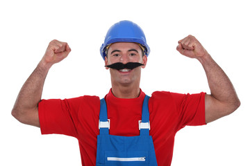 Muscular tradesman wearing a fake moustache