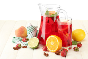 sangria in jar and glass with fruits,