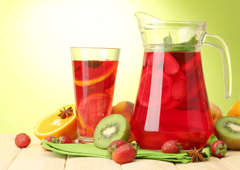 sangria in jar and glass with fruits,
