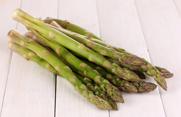 Fresh asparagus on white wooden table background