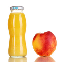 Delicious peach juice in glass bottle and peach next to it