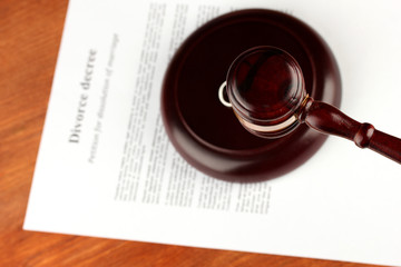 Divorce decree and wooden gavel on wooden background