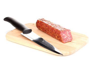 Tasty sausage on chopping board isolated on white