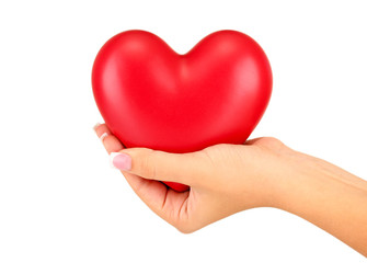 Fototapeta premium Red heart in woman's hand, on white background close-up