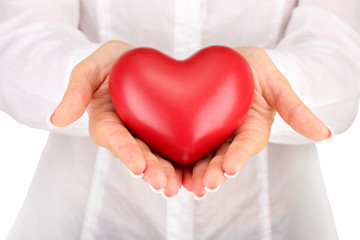 Red heart in woman's hands, on white background close-up