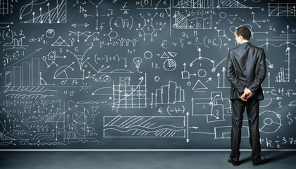 Business person against the blackboard