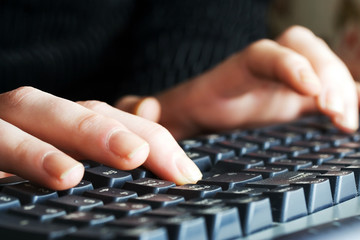 Female hands using computer keyboard