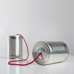 Can telephone with red wire. Conceptual communication image.