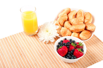 Breakfast with berries,orange juice and croissant