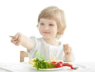 Smiling little girl showing her table knife