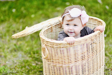 Cute little girl in a basket