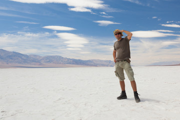 Lonely man on salt desert. Death Valley. USA.