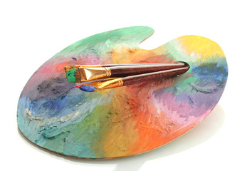 wooden art palette with paint and brushes isolated on white