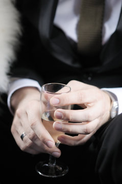 Groom holding wedding champagne glass