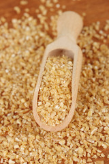 arnautka in wooden spoon on wooden background close-up