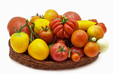 red and yellow tomatoes in a basket