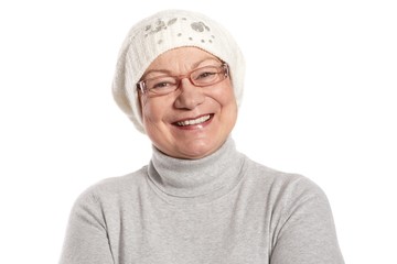 Portrait of happy elderly lady in cap