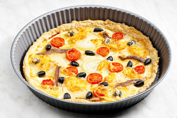 cake with anchovies, cherry tomatoes and black olives