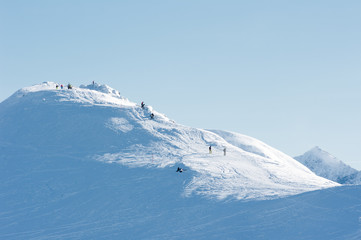 Obraz premium People on the snow-covered mountain peaks.