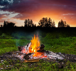 Fireplace in forest at dusk