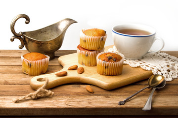 Muffins on wooden table and white background