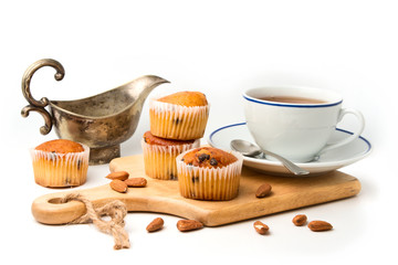 Muffins on wooden cutting board on white background