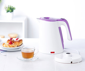 White kettle electric water boiler isolates in the kitchen