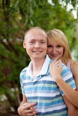 Fototapeta premium Portrait of young couple in love having fun in the park