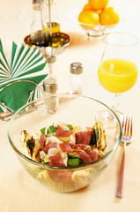 Salad with smoked duck fillet on a laid table