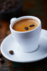 Cup of espresso with coffee beans