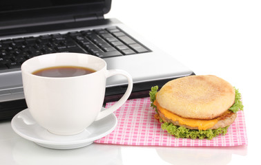 Eating at work place near laptop
