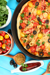 colorful composition of delicious pizza, vegetables and spices