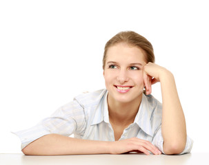 A businesswoman sitting at the desk, isolated on white