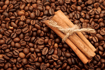 handful aromatic coffee beans with cinnamon