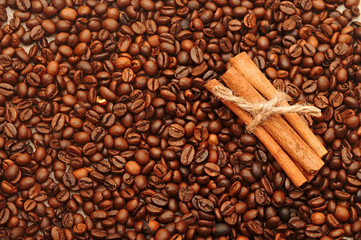 handful aromatic coffee beans with cinnamon